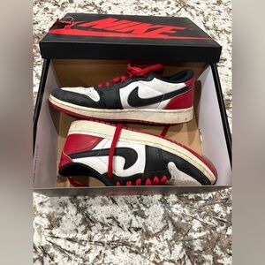 Air Jordan 1 Retro Low OG. Nike Black, Red, and White Low-Top Sneakers
